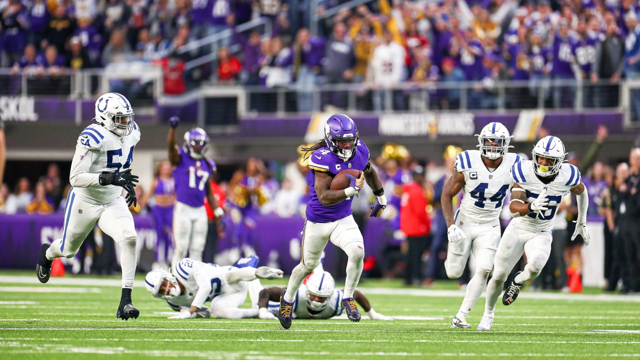 Indianapolis Colts vs. Minnesota Vikings. Fans support on NFL Game.  Silhouette of supporters, big screen with two rivals in background. Stock  Photo