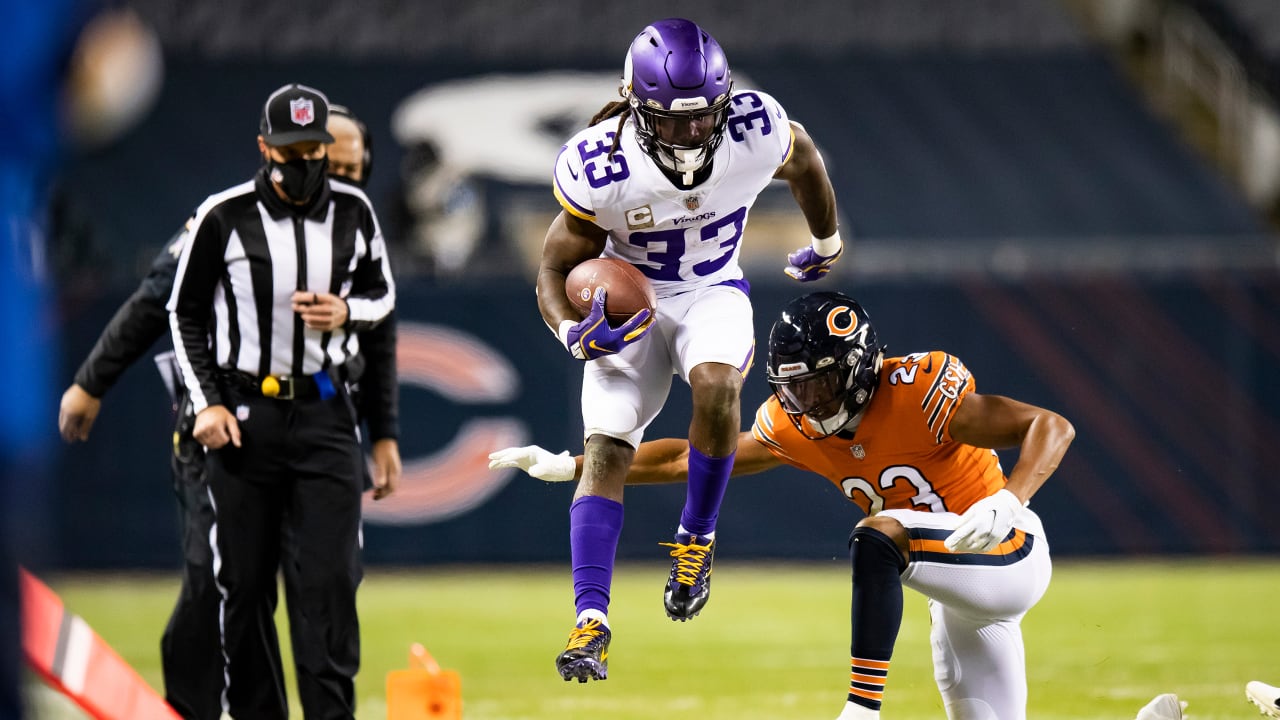 Dalvin Cook of the Minnesota Vikings runs with the ball as Eddie