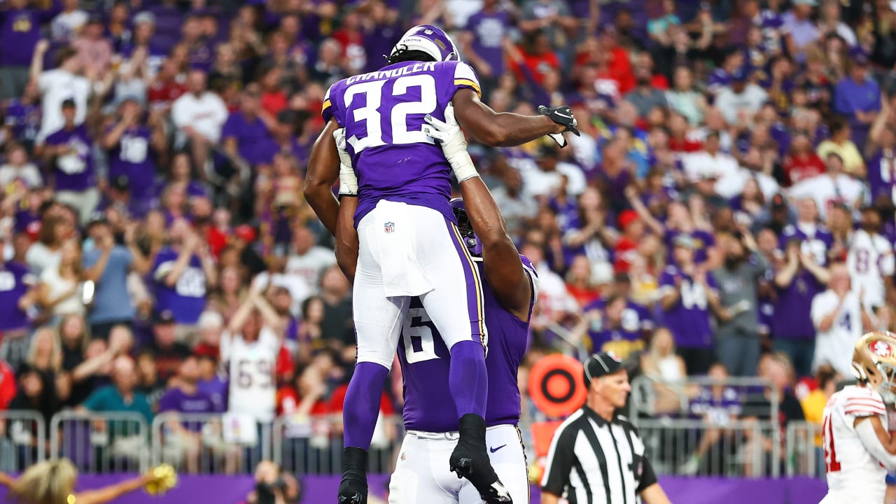 Minnesota Vikings running back Ty Chandler (32) warms up before an