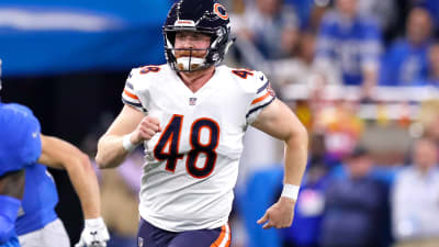 Chicago Bears long snapper Patrick Scales holds his daughter