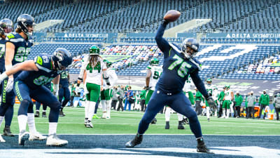 Seattle Seahawks' linebacker D.D. Lewis (54) hits Indianapolis Colts' wide  receiver Troy Rogers as he catches the ball during the second quarter of an NFL  football game Saturday, Dec. 24, 2005 in