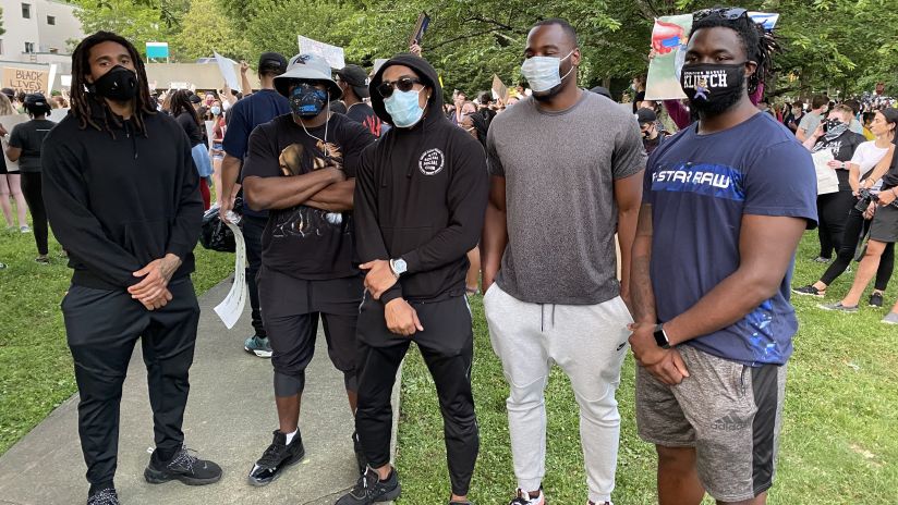 Shaq Thompson, Andre Smith, Tre Boston, Chris Manhertz and Ian Thomas at the justice walk in Charlotte on Monday.