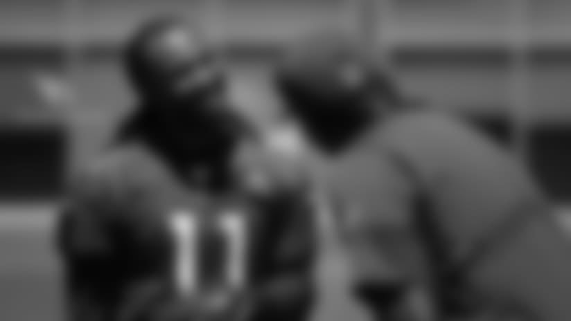 WR Larry Fitzgerald jokes with QB coach Byron Leftwich