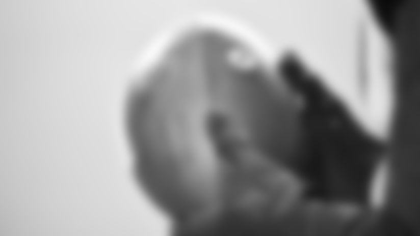 Gloved hands holding football