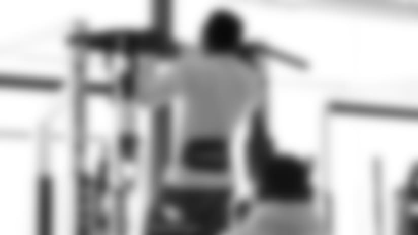 RB Chase Edmonds does pull-ups during the weight-lifting session.