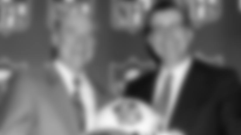 NFL commissioner Paul Tagliabue and Houston businessman Bob McNair, left, smile during a press conference in Atlanta Wednesday, Oct. 6, 1999. Houston rejoined the NFL, paying a record $700 million for an expansion franchise and beating out Los Angeles, the nation's second-largest TV market. . (AP Photo/W. A. Harewood)