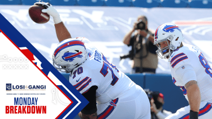 Buffalo Bills' Jerry Hughes gets his helmet stuck on teammate's jersey