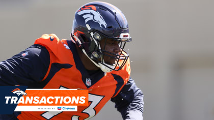 Denver Broncos offensive tackle Cam Fleming watchs the action from