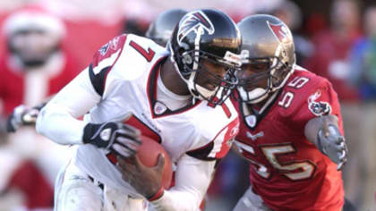 Warrick Dunn of the Atlanta Falcons runs out of the tackle of