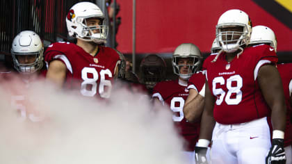 U.S military personnel stand of the field before an NFL football game  between the Arizona Cardinals