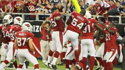 Dallas Cowboys quarterback Tony Romo looks back at the Arizona Cardinals  celebration after blocking a Cowboys punt in overtime for a touchdown to  defeat the Cowboys 30-24 at University of Phoenix Stadium