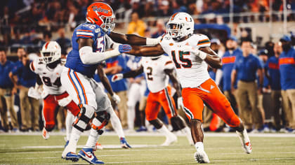 Defensive end Gregory Rousseau reacts to being drafted by the