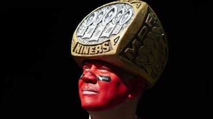 A San Francisco 49ers fan sports a Super Bowl ring hat and holds a sign  before Monday Night Football against the Chicago Bears at Candlestick Park  in San Francisco on November 19