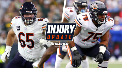 Chicago Bears offensive tackles Larry Borom (75) and Aviante Collins (74)  walk off the field after the first half of an NFL preseason football game  against the Tennessee Titans, Saturday, Aug. 12