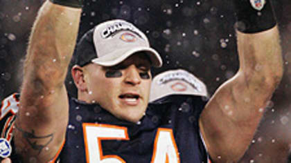 Chicago Bears' Brian Urlacher (54) holds up the NFC Championship Trophy  after the Bears beat the New Orleans Saints 39-14 in the NFC Championship  game at Soldier Field in Chicago on January