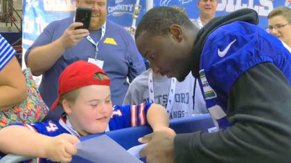 Rory Cavalier (left) receives Bills game tickets from running back LeSean McCoy (right).