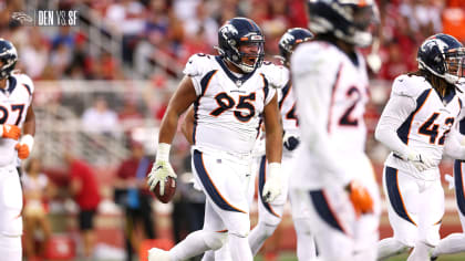 Denver Broncos defensive lineman Elijah Garcia engulfs Arizona Cardinals  quarterback David Blough for a 7-yard sack