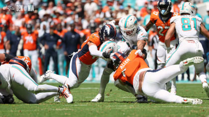 Denver Broncos linebacker Randy Gregory, back, looks on as Denver Broncos  linebacker Marcus Haynes, front left, takes part in a drills with  linebacker Thomas Incoom during an NFL football training camp at