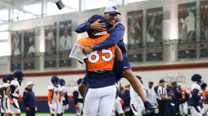 Denver Broncos tight ends coach Jake Moreland chats with tight end Eric  Saubert as he takes part in drills during the NFL football team's training  camp Thursday, Aug. 4, 2022, at the