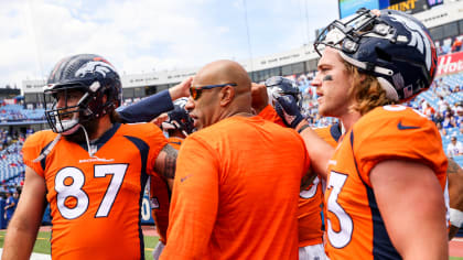 Denver Broncos tight ends coach Jake Moreland chats with tight end Eric  Saubert as he takes part in drills during the NFL football team's training  camp Thursday, Aug. 4, 2022, at the