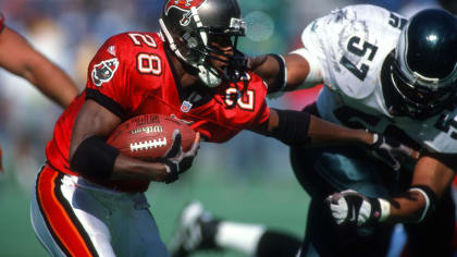 Dec. 9, 2012 - Tampa, Florida, U.S. - Tampa Bay Buccaneers 2002 Superbowl  team QB Brad Johnson gets a high five from the Bucs mascot as he runs onto  the field as