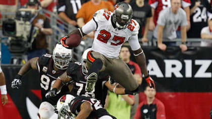 Tampa Bay Buccaneers running back LeGarrette Blount (L) hurdles Arizona  Cardinals Kerry Rhodes (R) in the fourth quarter of the game Cardinals at  University of Phoenix Stadium in Glendale, AZ October 31,2010.