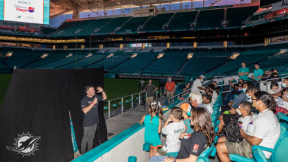 Miami Dolphins defensive players and Ashley HomeStore Deliver Beds to South  Florida Families 