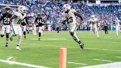 Miami Dolphins quarterback Trent Green (10) tucks the ball under pressure  from the Dallas Cowboys defense. The Cowboys defeated Dolphins, 37-20, at  Dolphin Stadium in Miami, Florida, Sunday, September 16, 2007. (Photo