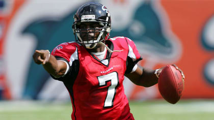 Former Atlanta Falcons and Philadelphia Eagles quarterback Michael Vick  wears one of his special edition New Era hats on sale in the NFL Shop at  the Super Bowl Experience on Thursday, Jan.