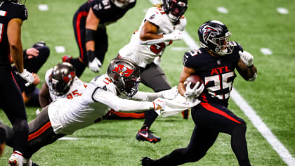 Atlanta Falcons offensive tackle Kaleb McGary (76), left, works against an  unidentifed teammate during the first day of team's NFL football training  camp pratice Wednesday, July 26, 2023, in Flowery Branch, Ga. (