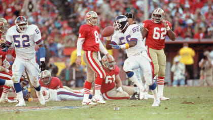 New York Giants quarterback Jeff Hostetler does a little scrambling to  avoid Chicago Bears Steve McMichael (rear) and Trace Armstrong (93) during  third quarter action in NFL playoff game, Sunday, Jan. 14