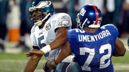 New York Giant quarterback Jeff Hostetler threads his way through Phoenix  Cardinals defenders on his way to a 19 yard touchdown during the first  quarter of their game in Tempe, Arizona Sunday