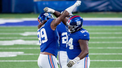 New York Giants quarterback Charley Conerly (42) hands off the ball to Alex  Webster (29) as part of a double hand-off and lateral play resulting in the  only touchdown of the NFC