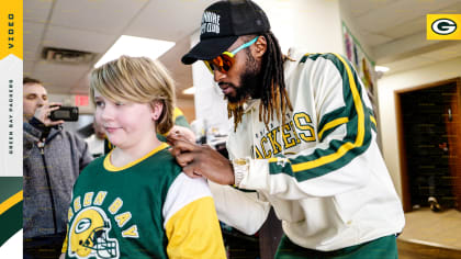 Green Bay Packers center Scott Wells holds his baby and the Vince