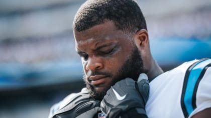 Carolina Panthers defensive tackle Marquan McCall (left) exchanges