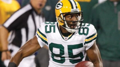 Green Bay Packers wide receiver Greg Jennings is hit by Oakland