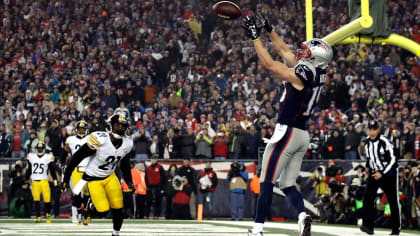 New England Patriots quarterback Tom Brady (12) sails after being hit by Denver  Broncos cornerback Aqib Talib on a first down run in the second quarter  during the AFC Championship game at