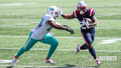 Miami Dolphins running back Myles Gaskin, left, is tackled by New England  Patriots cornerback Joejuan Williams, right, during the second half of an  NFL football game, Sunday, Sept. 12, 2021, in Foxborough