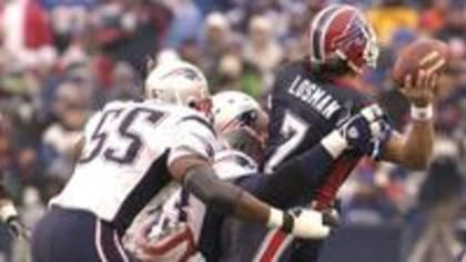 Buffalo Bills quarterback Doug Flutie avoids a tackle from New