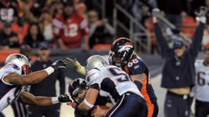 New England Patriots defensive lineman Gerard Warren (98) sacks Denver  Broncos quarterback Tim Tebow (15) in the second quarter of the AFC  divisional playoff game at Gillette Stadium in Foxboro, Massachusetts on