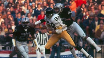 George Atkinson, right, of the Oakland Raiders jumps for joy after breaking  up a pass from the Steelers Terry Bradshaw to Lynn Swann (88) on Dec. 26,  1976 in Oakland. Atkinson was