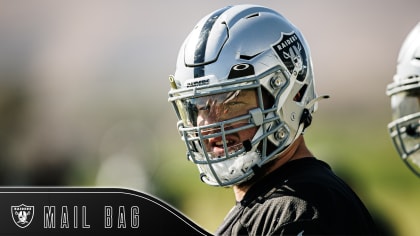 Las Vegas Raiders center Andre James walks with trainers after an