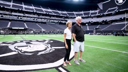 Former Raider tight end Dave Casper stands with a signed jersey, a bottle  of Robert Mondovi Wine . a guitar and a famous Herman Miller Alron Chair,  all part of a fundrainser