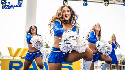 Los Angeles Rams cheerleaders pose with a child during - PICRYL