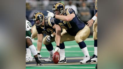 Workers removing Rams banners from the Edward Jones Dome