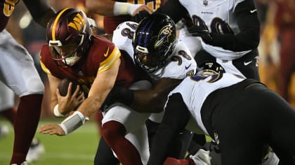 Baltimore Ravens defensive tackle Travis Jones (98) walks off the