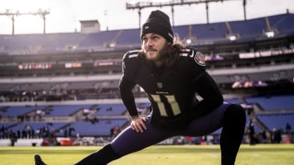 Baltimore Ravens punter Jordan Stout (11) follows through on a kick in the  first half of an NFL football game against the New England Patriots,  Sunday, Sept. 25, 2022, in Foxborough, Mass. (