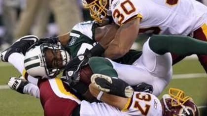 Clinton Portis is tackled by Nick Ferguson in the third quarter of