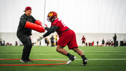 Washington Commanders linebacker David Mayo (51), defensive tackle  Phidarian Mathis (98) and linebacker Khaleke Hudson (47) pursue a play  during practice at the team's NFL football training facility, Tuesday, Aug.  9, 2022