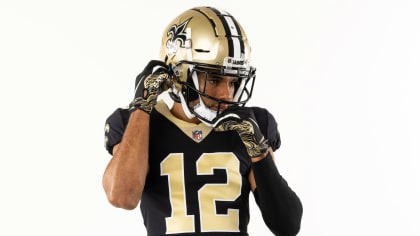 New Orleans Saints wide receiver Chris Olave wears his helmet